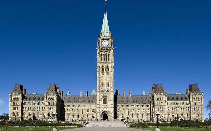 Centre Block of Canada's Parliament with the Peace Tower in Ottawa under a clear blue sky