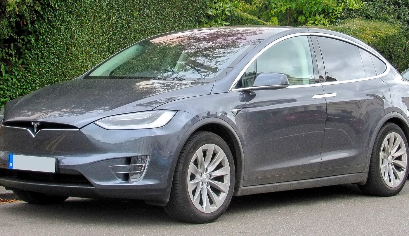 White Tesla Model X 100D parked, front three-quarter view