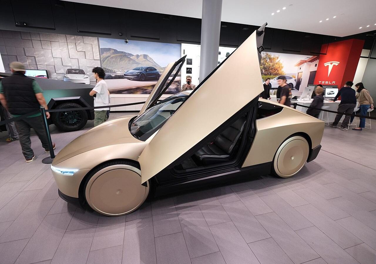 Gold Tesla Cybercab robotaxi parked outdoors at an angle
