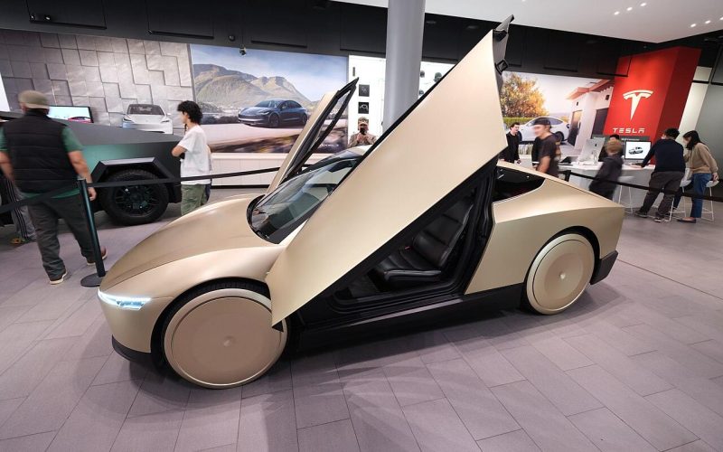 Gold Tesla Cybercab robotaxi parked outdoors at an angle