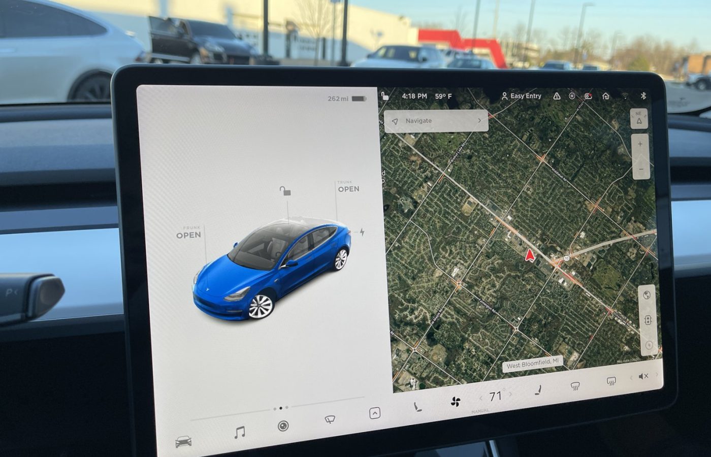 Tesla Model 3 centre touchscreen showing the car view and satellite navigation map