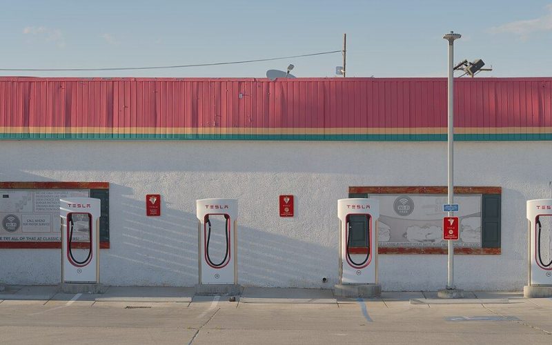 Tesla Supercharger stalls with charging cables at a station
