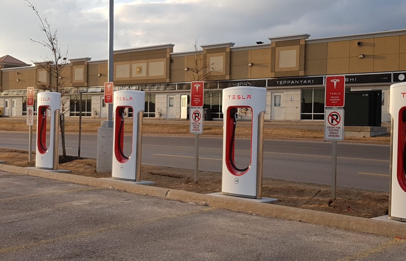 Row of Tesla Supercharger posts in a parking lot at Vaughan Mills, Ontario.