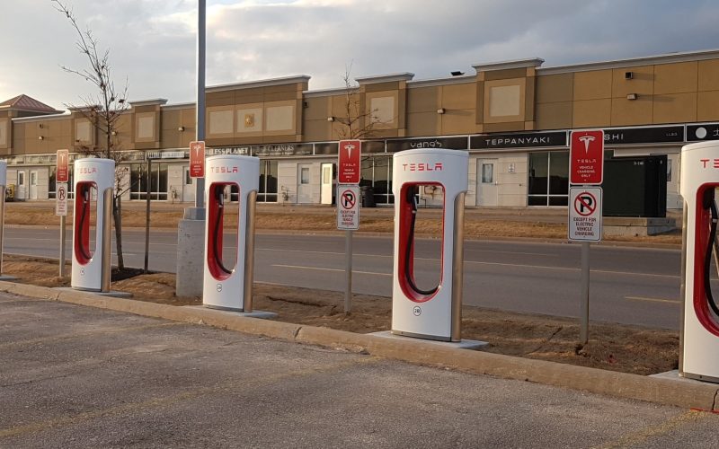 Row of Tesla Supercharger posts in a parking lot at Vaughan Mills, Ontario.